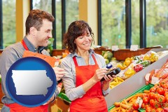 iowa map icon and two grocers working in a grocery store