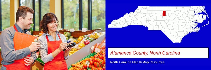 two grocers working in a grocery store; Alamance County, North Carolina highlighted in red on a map