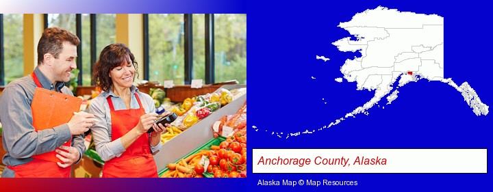 two grocers working in a grocery store; Anchorage County, Alaska highlighted in red on a map