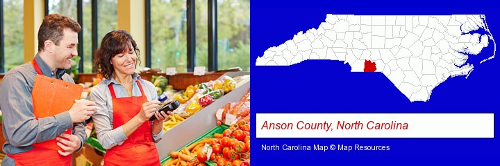 two grocers working in a grocery store; Anson County, North Carolina highlighted in red on a map