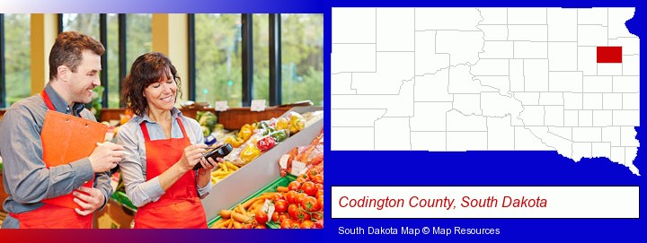 two grocers working in a grocery store; Codington County, South Dakota highlighted in red on a map