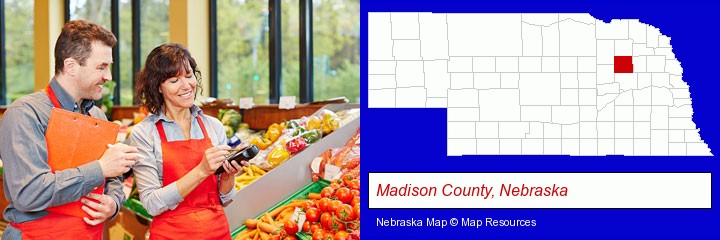 two grocers working in a grocery store; Madison County, Nebraska highlighted in red on a map