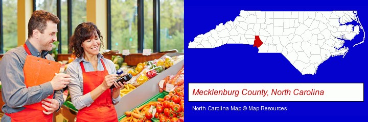 two grocers working in a grocery store; Mecklenburg County, North Carolina highlighted in red on a map