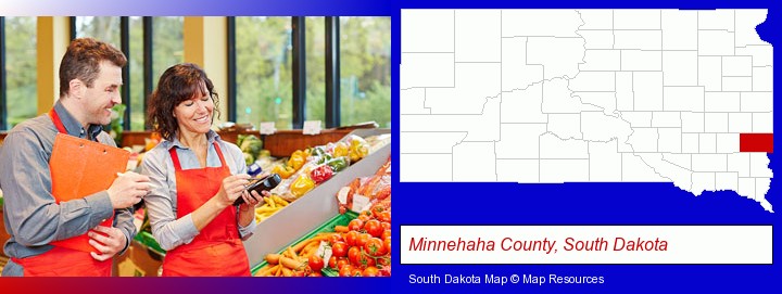 two grocers working in a grocery store; Minnehaha County, South Dakota highlighted in red on a map