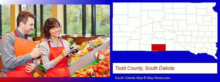 two grocers working in a grocery store; Todd County, South Dakota highlighted in red on a map