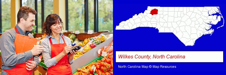 two grocers working in a grocery store; Wilkes County, North Carolina highlighted in red on a map