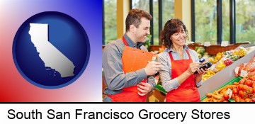 two grocers working in a grocery store in South San Francisco, CA